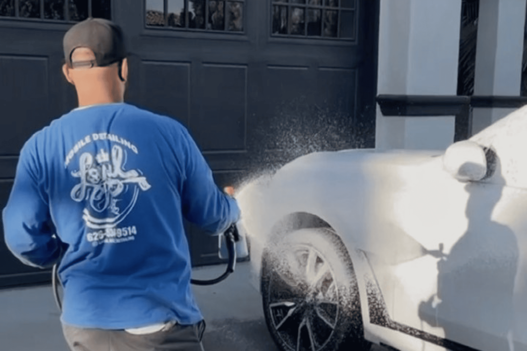 Professional detailer polishing a car